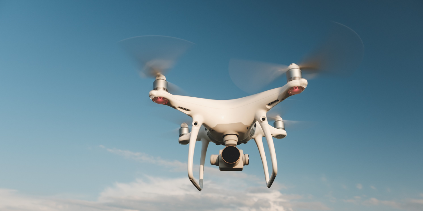 white-drone-hovering-bright-blue-sky-p61naqgwdnrp14mywvqs49ensfojq88vhtr0gg7sj2.png